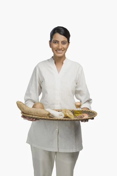 Woman holding a tray of products for aromatherapy — Stock Photo, Image