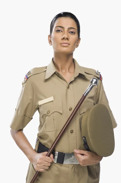 Female police officer holding a stick — Stock Photo, Image