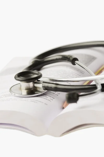 Stethoscope on an open book — Stock Photo, Image