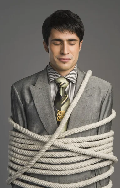 Businessman tied up with ropes — Stock Photo, Image