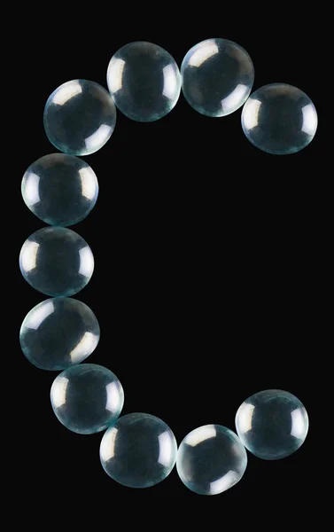 Marble balls arranged in the shape of letter C — Stock Photo, Image