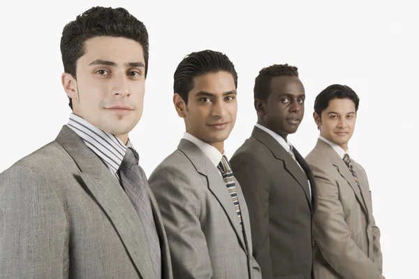 Four businessmen standing together — Stock Photo, Image