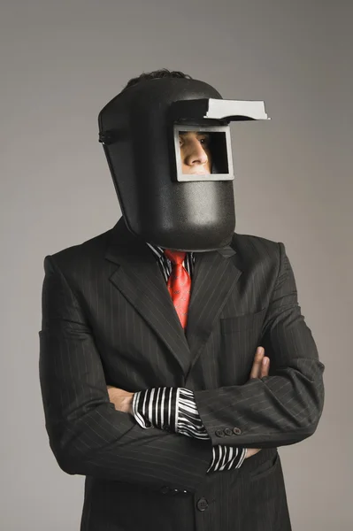 Businessman wearing a welding mask — Stock Photo, Image
