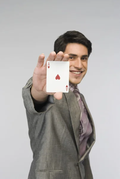Businessman showing ace of hearts card — Stock Photo, Image
