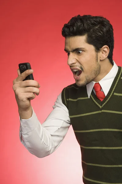 Businessman shouting on a mobile phone — Stock Photo, Image