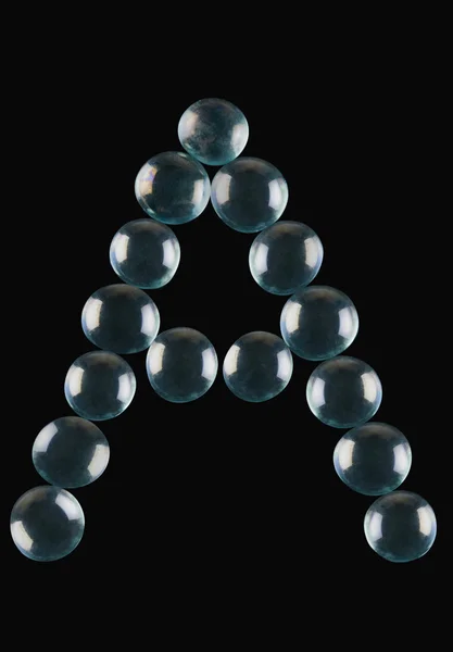Bolas de mármol dispuestas en forma de letra A — Foto de Stock