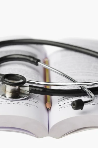 Stethoscope on an open book — Stock Photo, Image