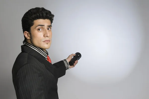Businessman holding a flashlight — Stock Photo, Image