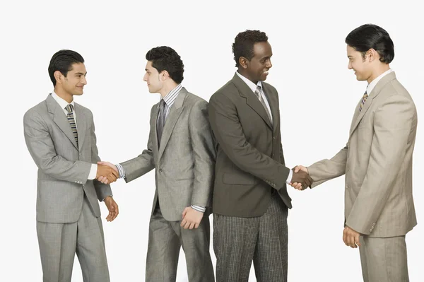 Four businessmen shaking hands — Stock Photo, Image