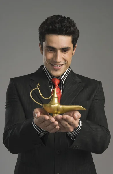 Businessman holding a magic lamp — Stock Photo, Image