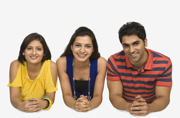 Three friends lying side by side — Stock Photo, Image