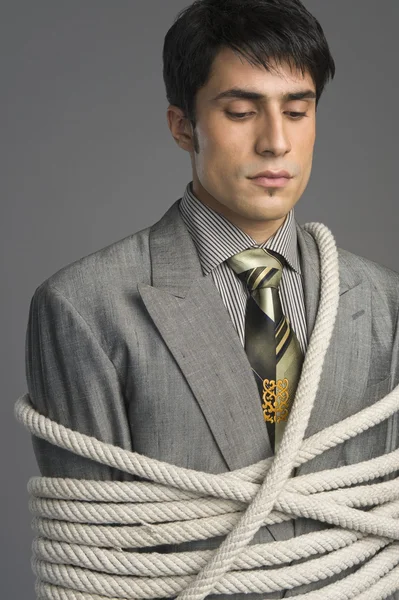 Businessman tied up with ropes — Stock Photo, Image