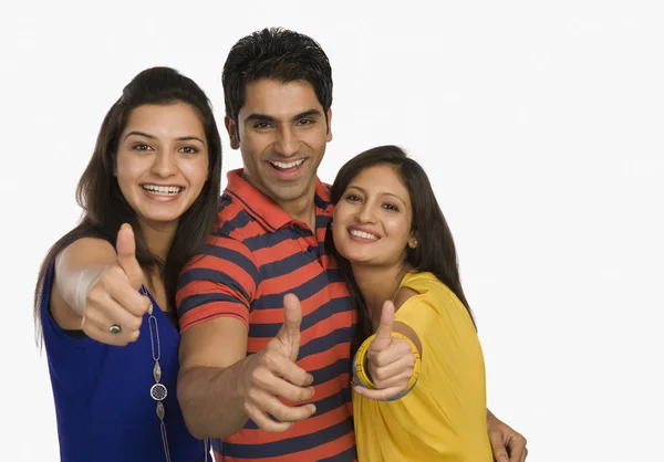 Three friends showing thumbs up sign — Stock Photo, Image