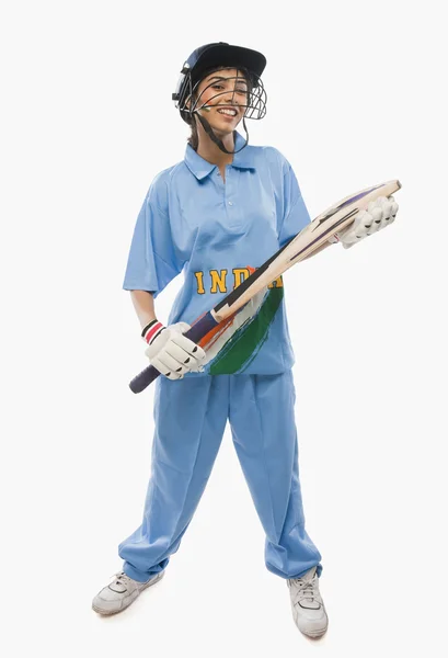 Female cricketer holding a cricket bat — Stock Photo, Image