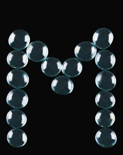 Bolas de mármol en forma de letra M — Foto de Stock