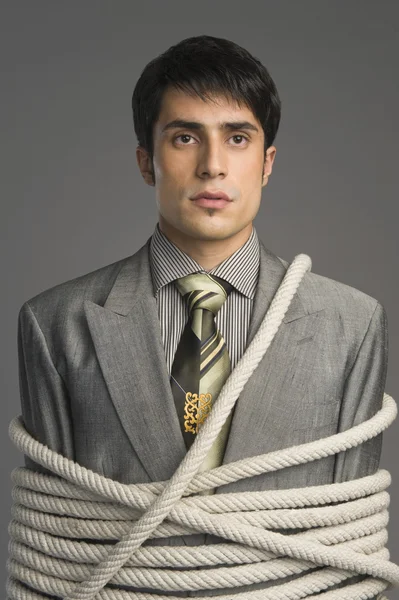 Businessman tied up with ropes — Stock Photo, Image