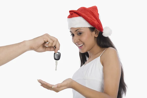 Woman surprised to see car key as a Christmas present — Stock Photo, Image