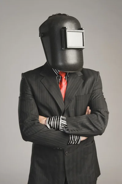 Businessman wearing a welding mask — Stock Photo, Image