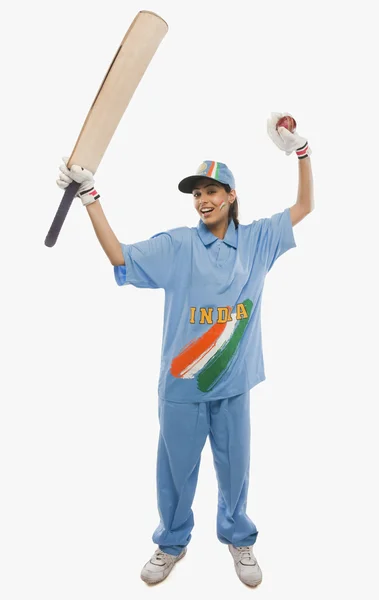 Female cricketer raising bat — Stock Photo, Image