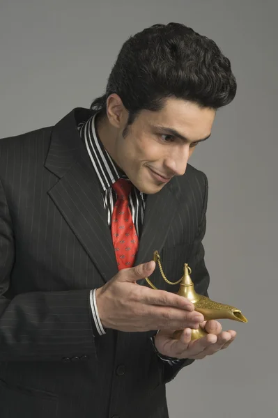 Businessman holding a magic lamp — Stock Photo, Image