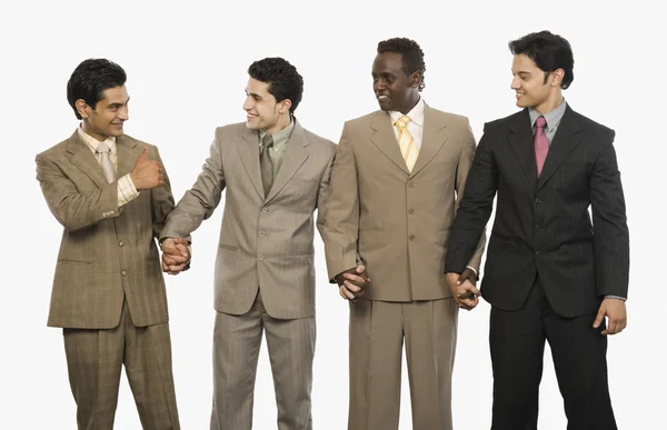 Businessmen standing with holding hands — Stock Photo, Image