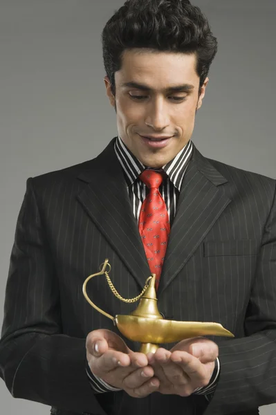 Businessman holding a magic lamp — Stock Photo, Image