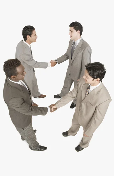 Four businessmen shaking hands — Stock Photo, Image