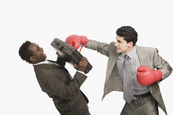 Businessman defending himself from the punch of his colleague — Stock Photo, Image