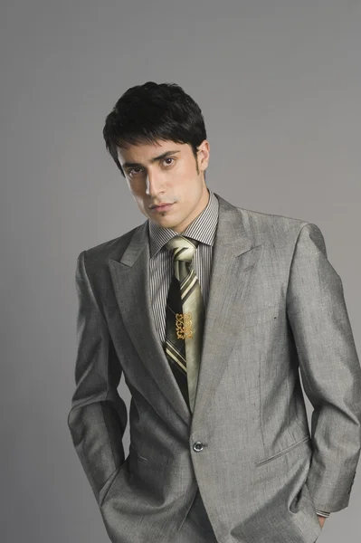 Businessman on grey background — Stock Photo, Image