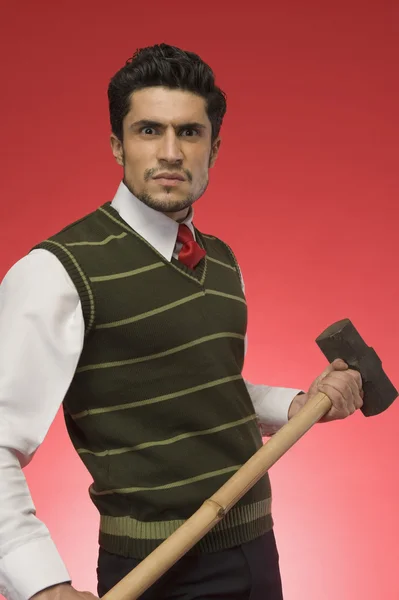 Businessman holding a sledgehammer — Stock Photo, Image