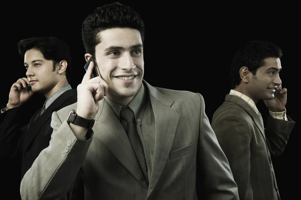 Businessmen talking on mobile phones — Stock Photo, Image