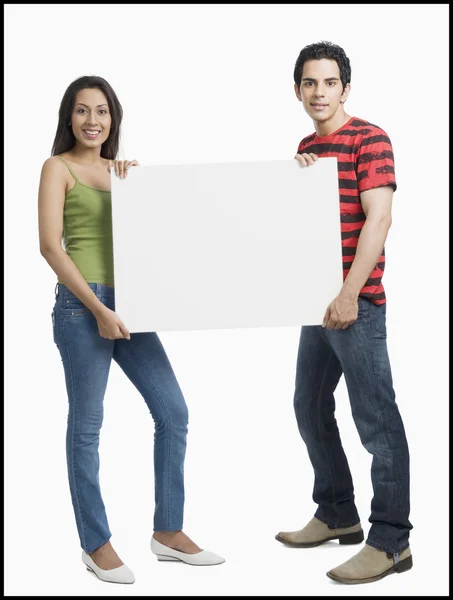 Couple holding a blank placard — Stock Photo, Image