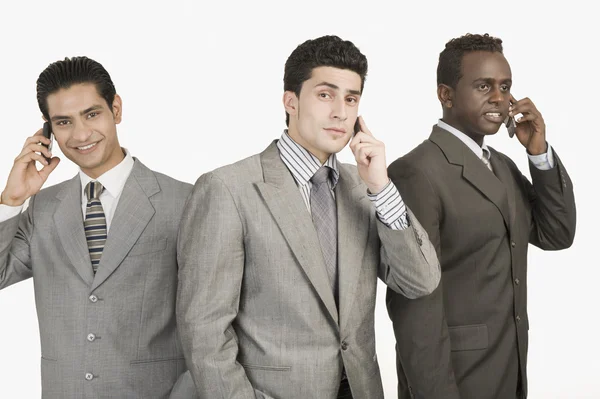 Tres hombres de negocios hablando en teléfonos móviles —  Fotos de Stock