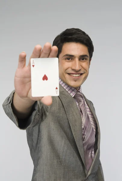 Businessman showing ace of hearts card — Stock Photo, Image