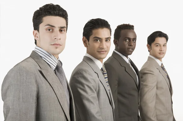 Four businessmen standing together — Stock Photo, Image