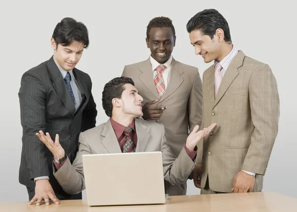 Businessmen in front of a laptop — Stock Photo, Image