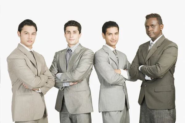 Four businessmen standing with arms crossed — Stock Photo, Image