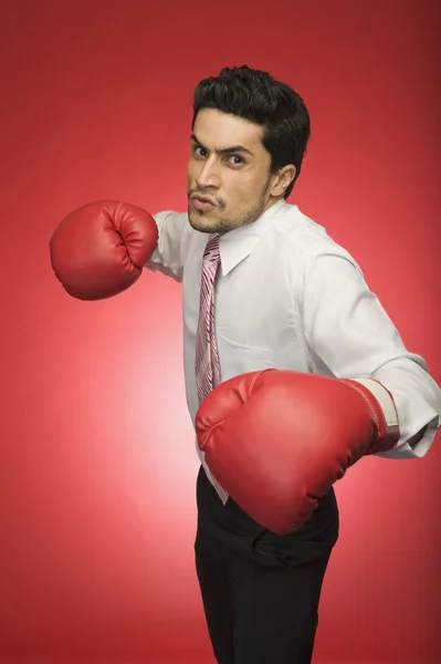 Businessman wearing boxing glove — Stock Photo, Image