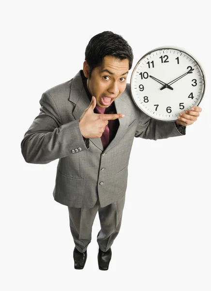 Businessman showing a clock — Stock Photo, Image