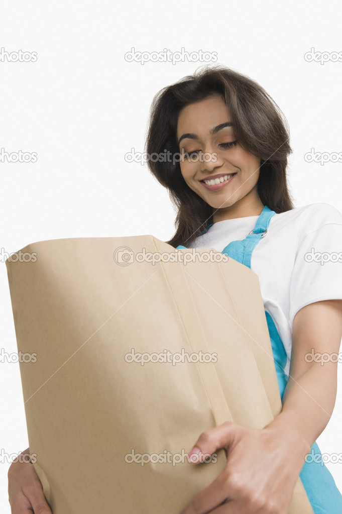 Woman looking into a paper bag
