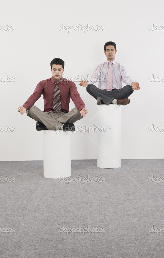 Businessmen practicing yoga