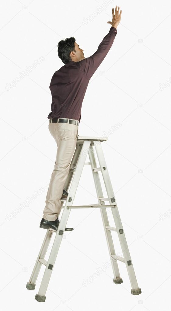 Businessman on a ladder