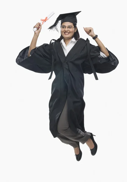 Woman jumping with her diploma — Stock Photo, Image