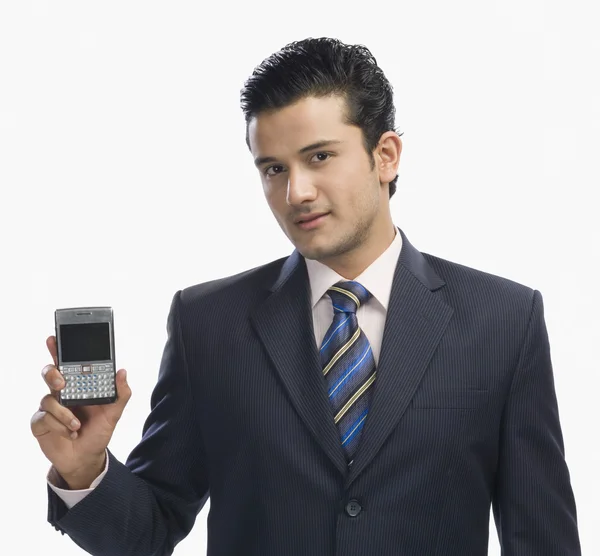 Businessman showing a mobile phone — Stock Photo, Image