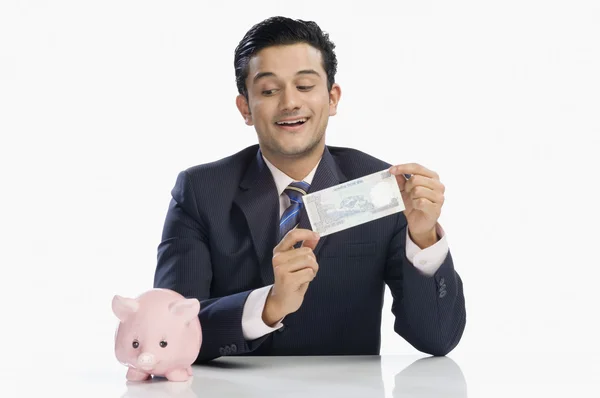 Businessman holding a currency note — Stock Photo, Image