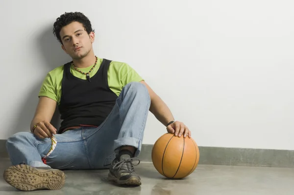 Man holding a ball with a mobile phone — Stock Photo, Image