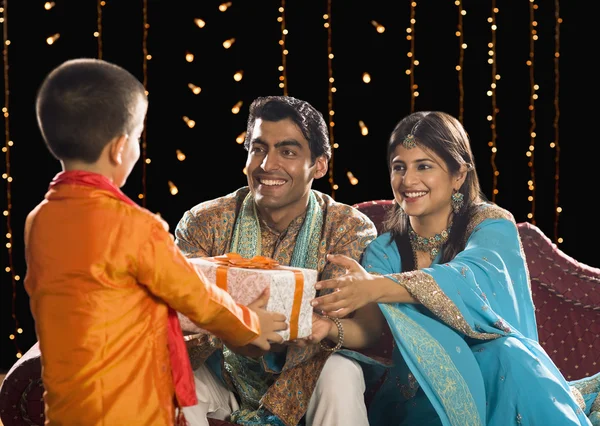 Couple giving Diwali gift to their son — Stock Photo, Image