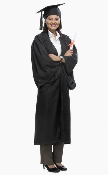 Woman holding a diploma in graduation gown — Stock Photo, Image