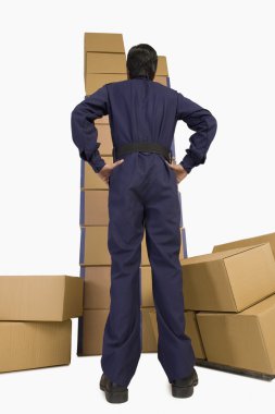 Store manager looking at cardboard boxes clipart