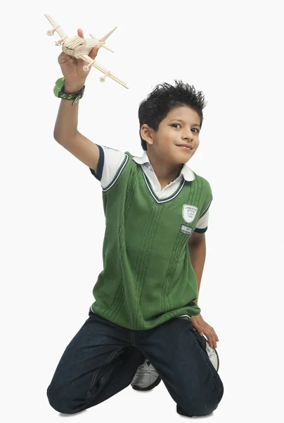 Boy playing with a toy airplane — Stock Photo, Image